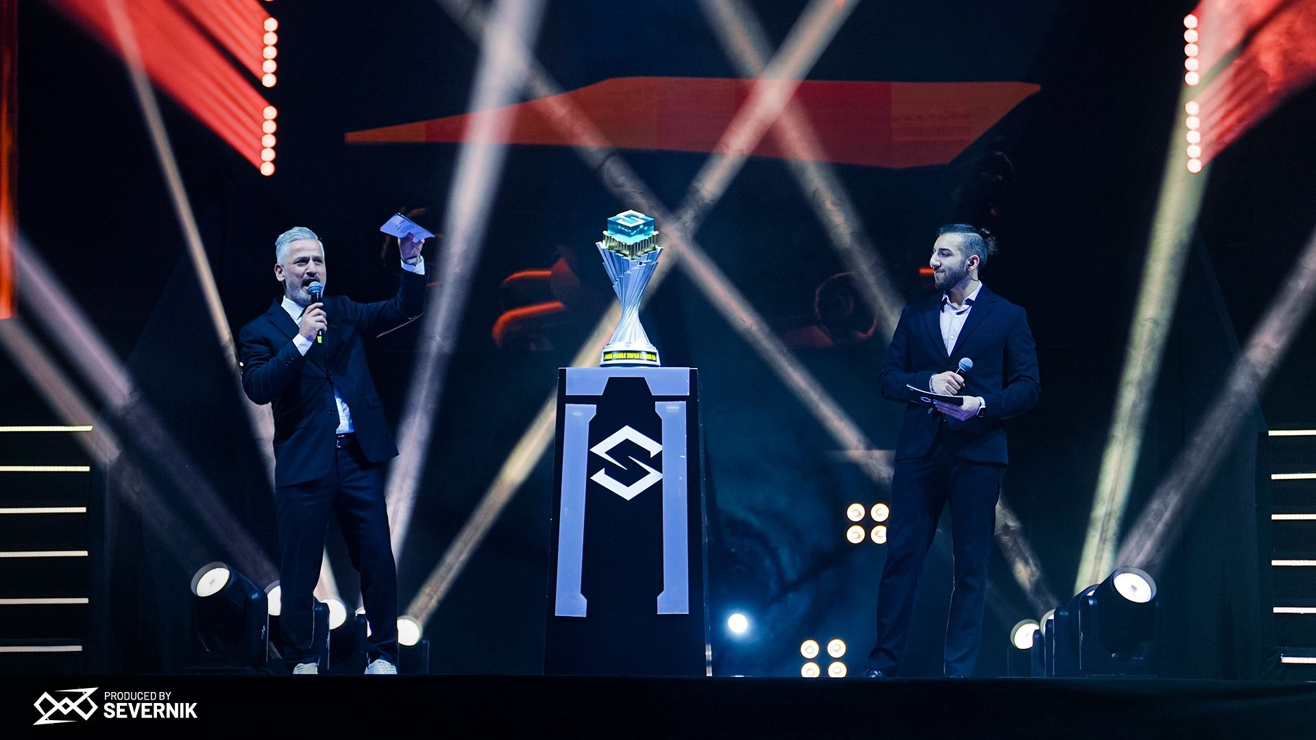 PMSL EU Fall Season hosts and trophy on stage